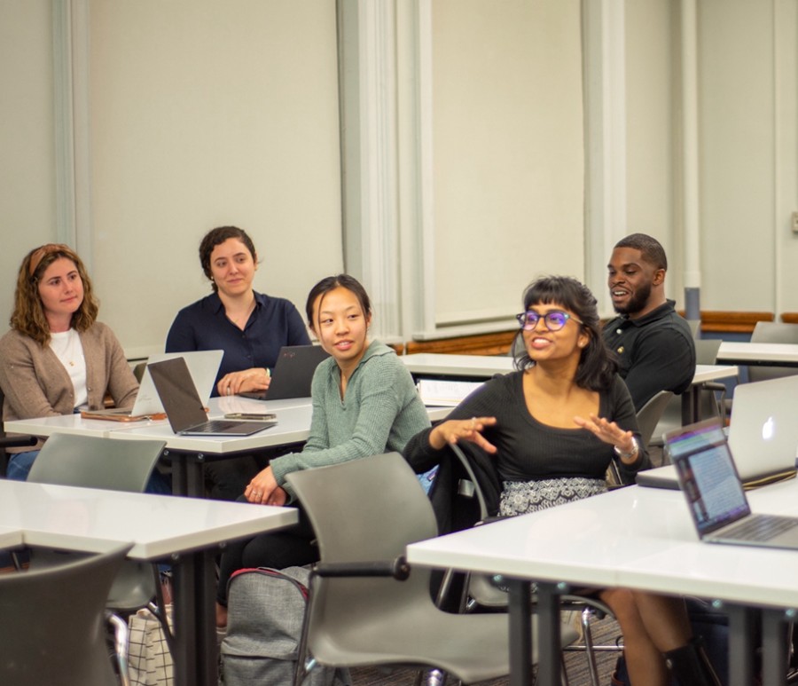 Group of five students sitting in a classroom