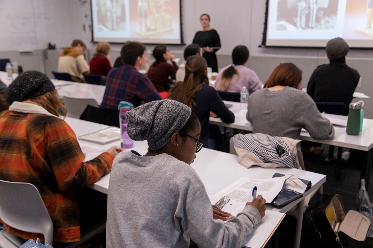 Students take notes in the classroom during a lecture