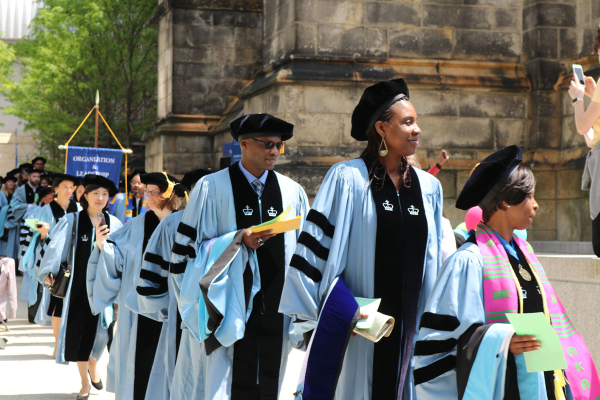 Doctoral students line-up for graduation in their hoods and gowns