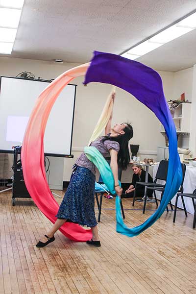 Teaching Artist and TC alumna Ling Tang performs a ribbon dance at a gathering for the Teachers College Teaching Artist Certificate program participants.