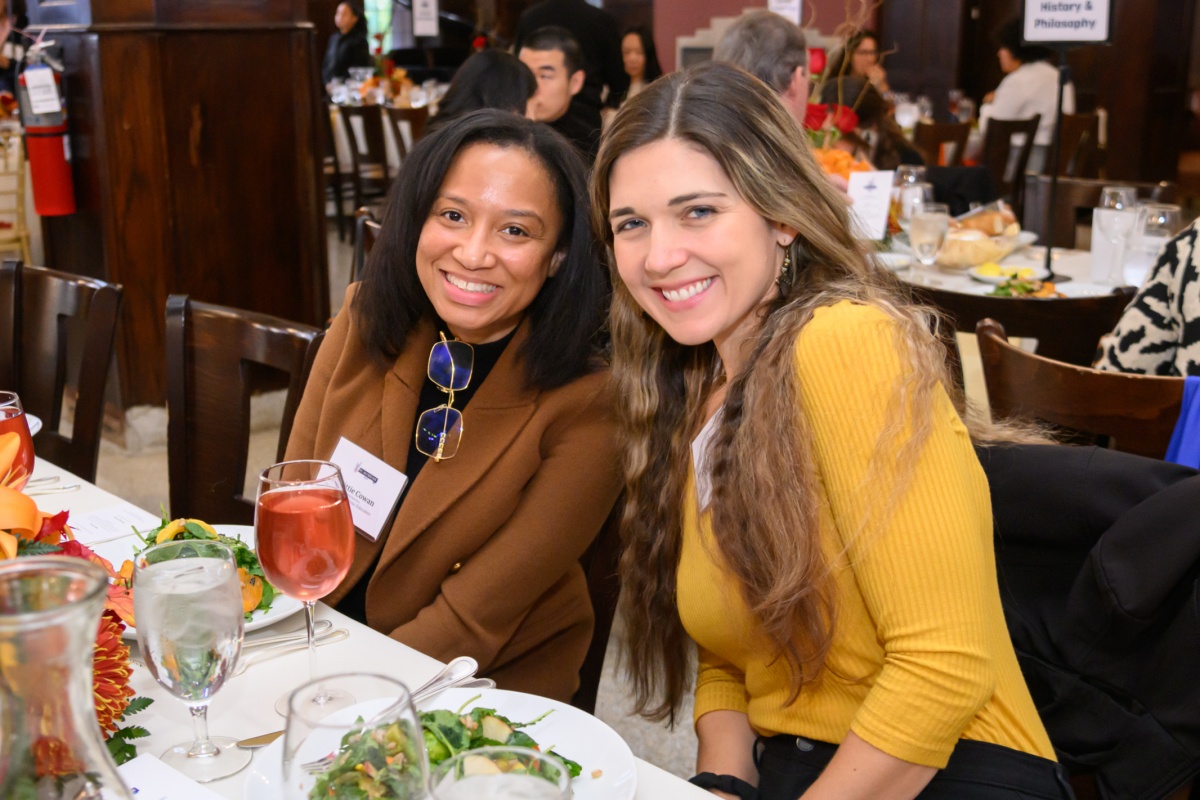 Guests smiling at Alumni Day