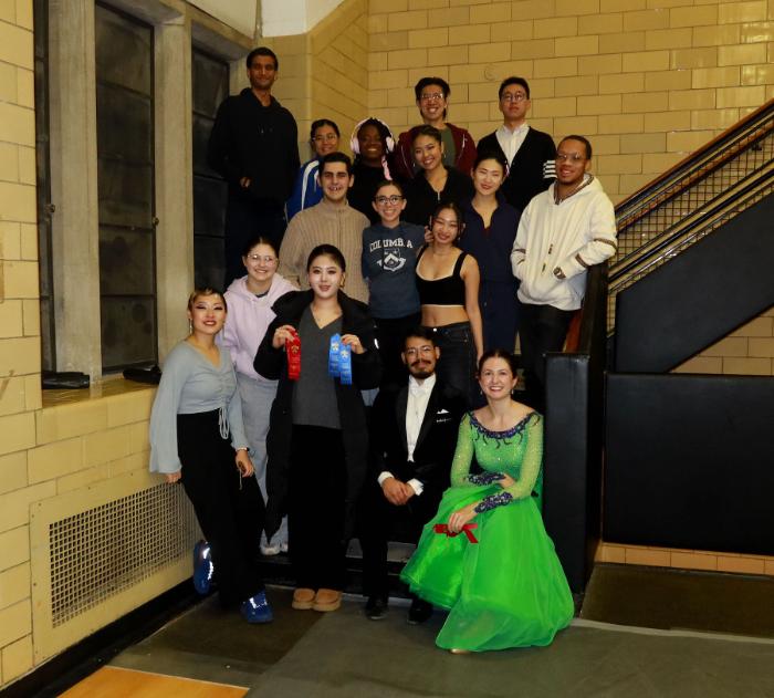 A group of students posing for a photo in a stairwell.