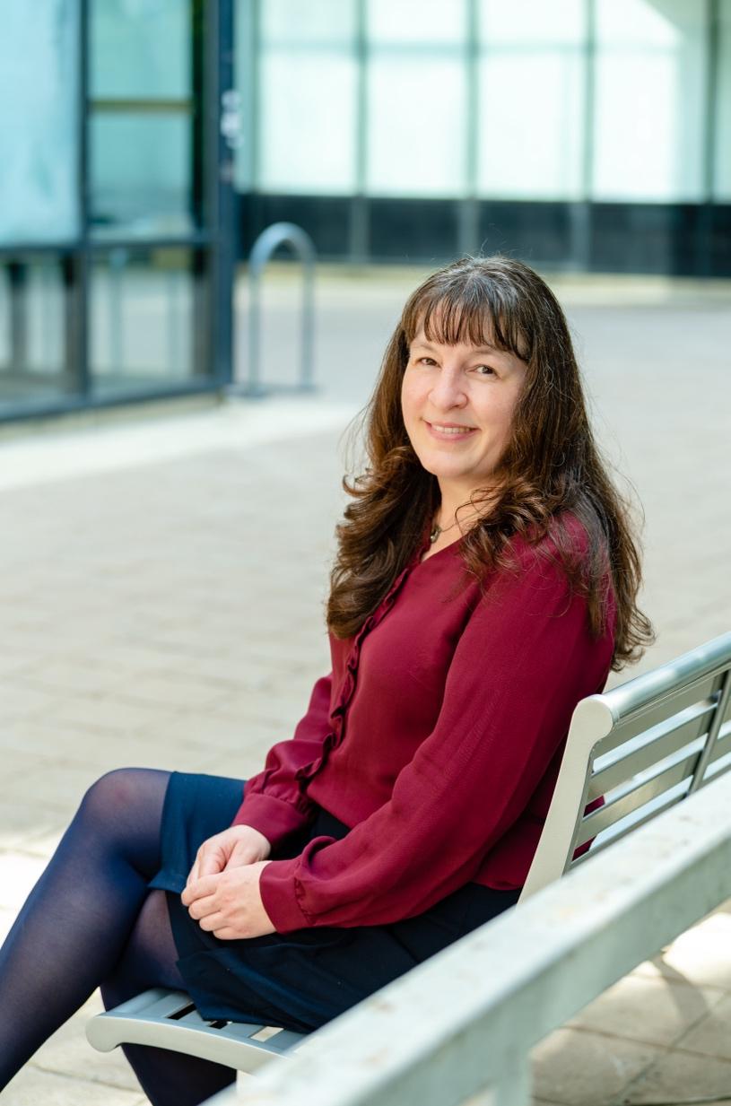 Picture of Dr. Rachel Talber sitting on bench smiling.