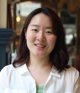 Joohyun smiling looking at camera