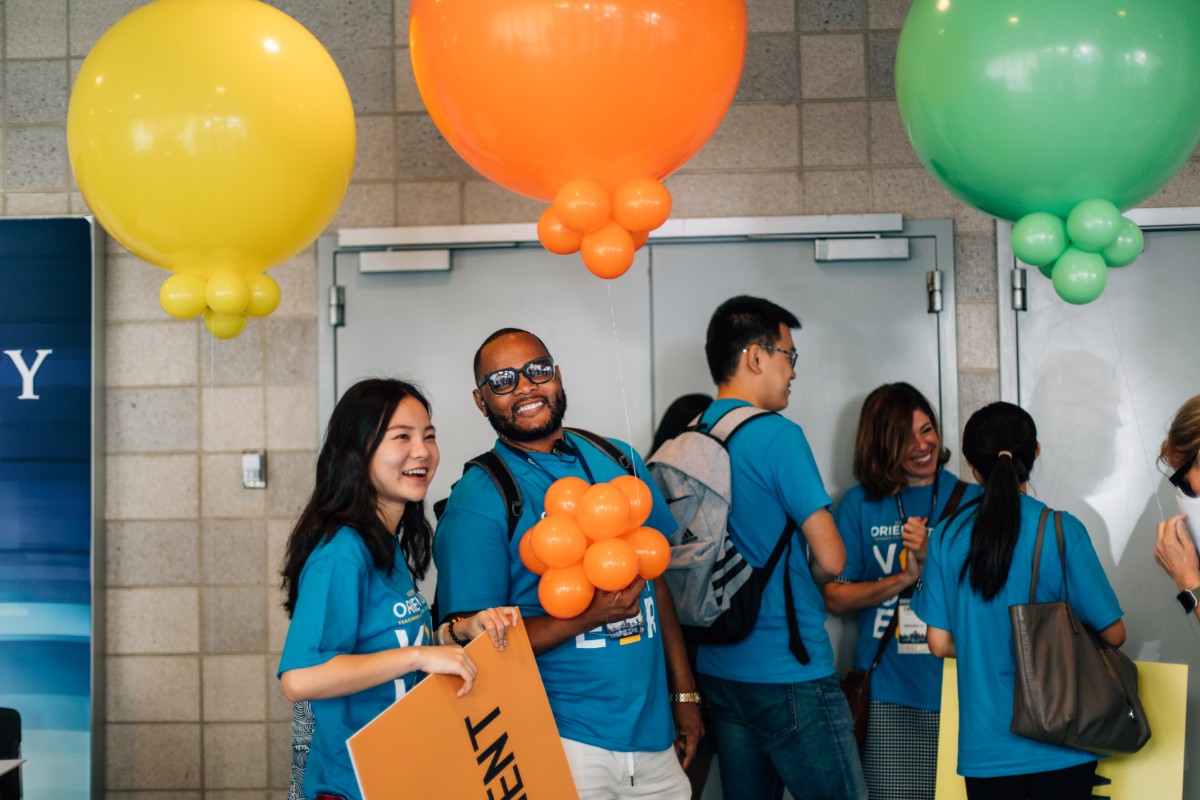 Students holding balloons at TC Orientation