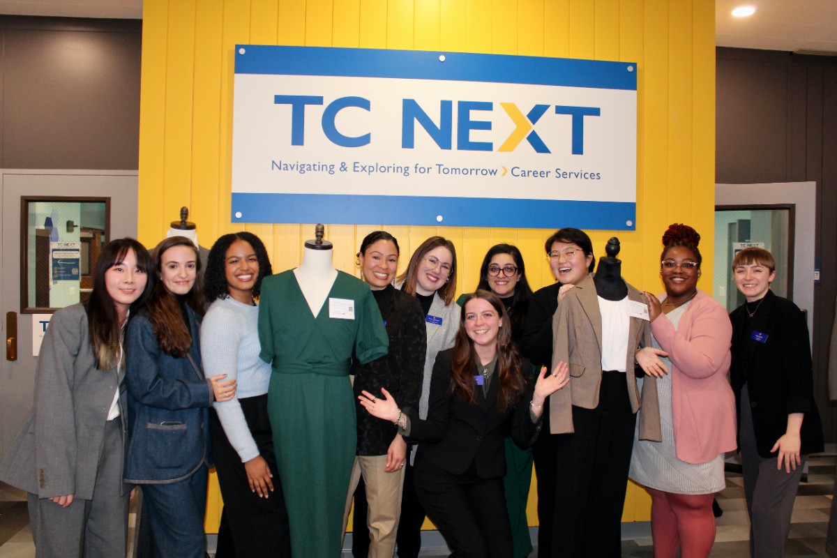 TC NEXT staff pose under TC NEXT sign with mannequins to celebrate the Cowin Career Closet opening