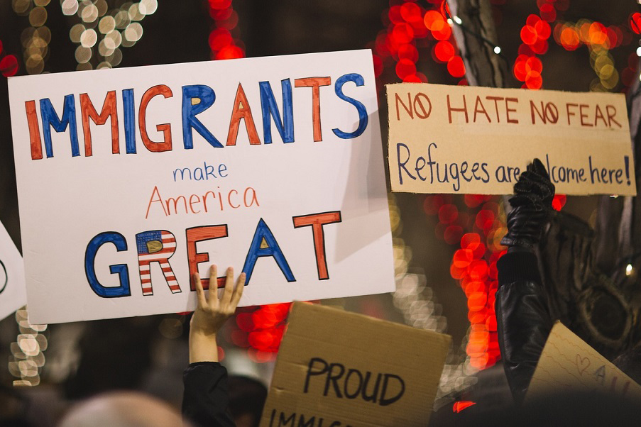 Protesters hold signs that say 
