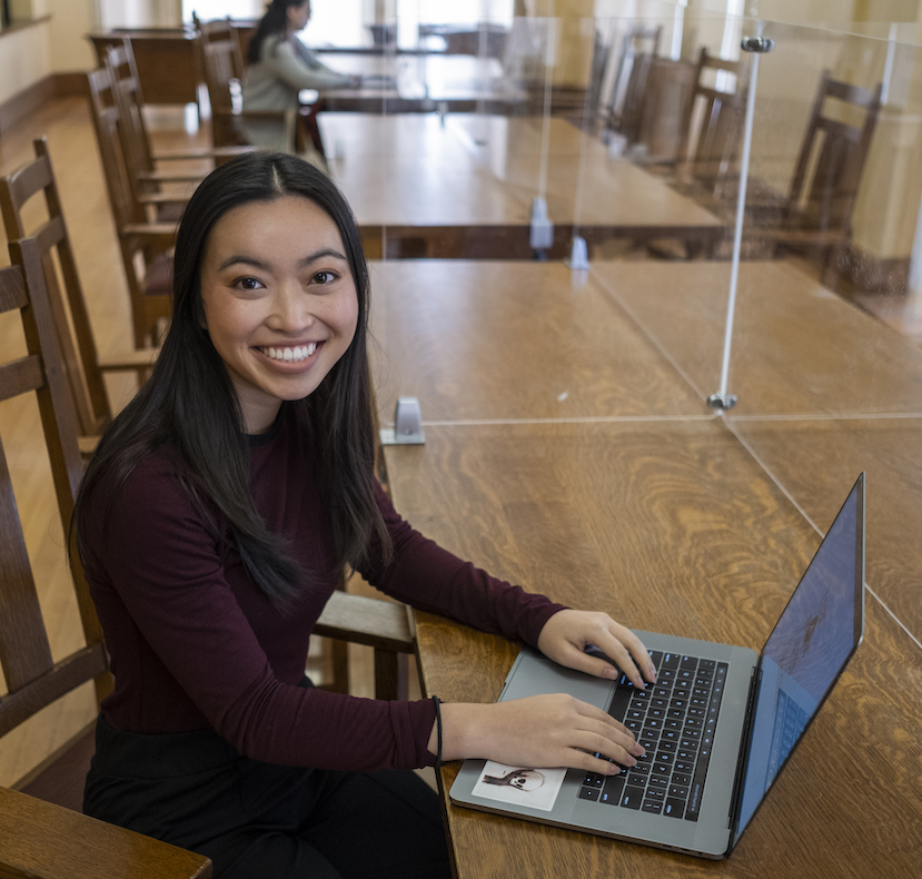 A woman with a laptop computer in the library