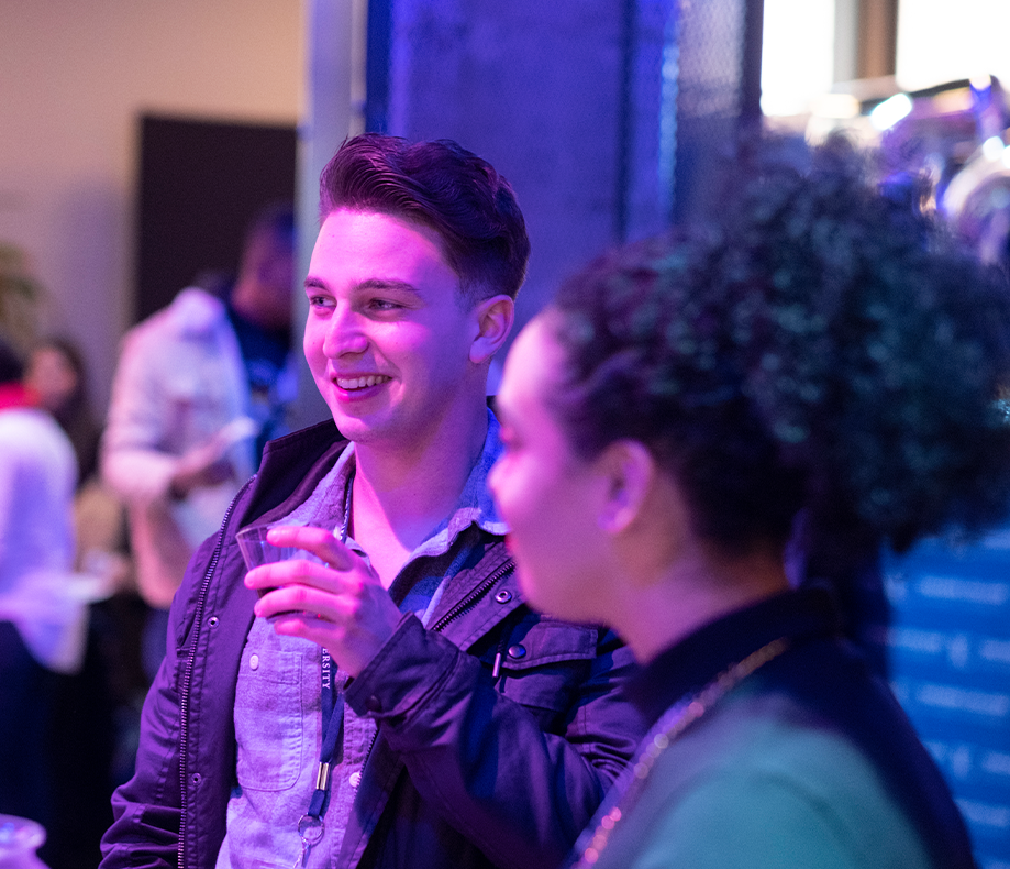 A student connecting with professionals in the field at a conference