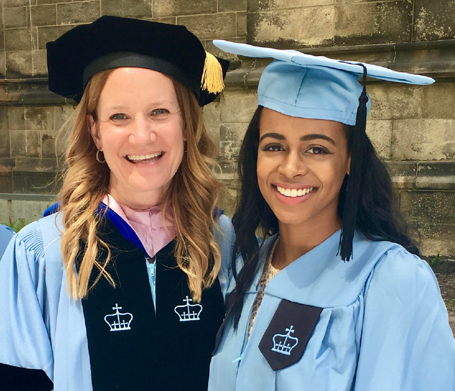 A professor and a student in graduation robes