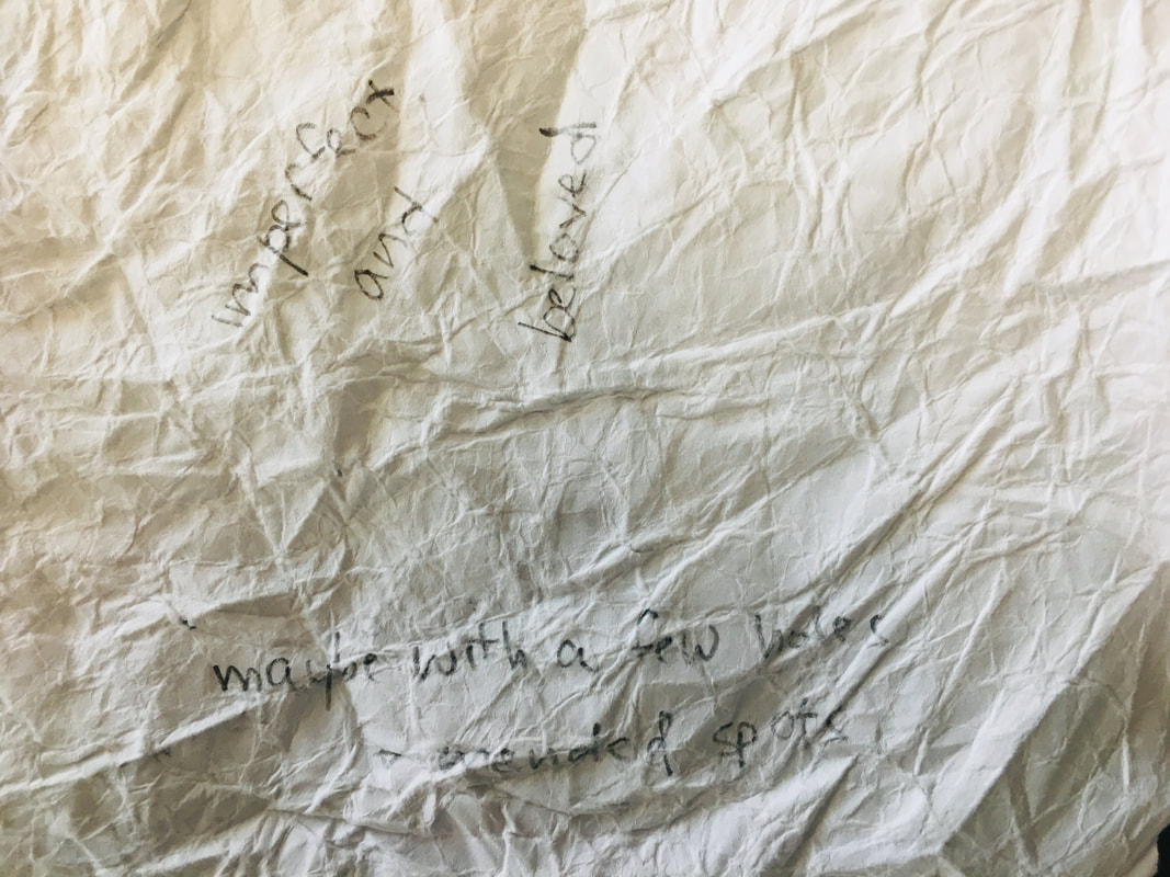 Crumpled paper with handwritten message in the middle of the material
