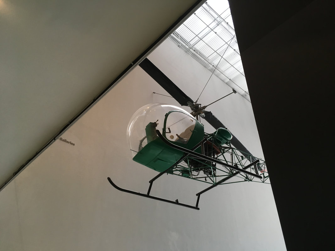 Green helicopter suspended from the ceiling