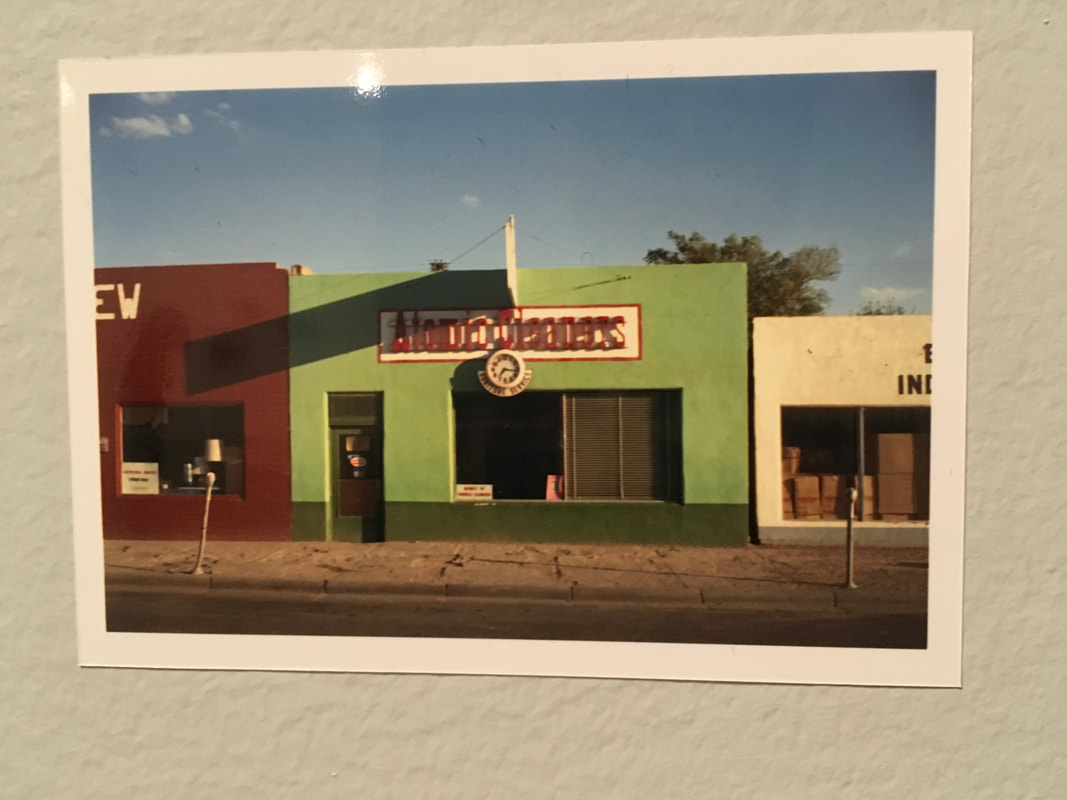 Image of Green building with red sign 