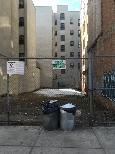 Cheap Divorce sign on fenced alleyway with green lettering