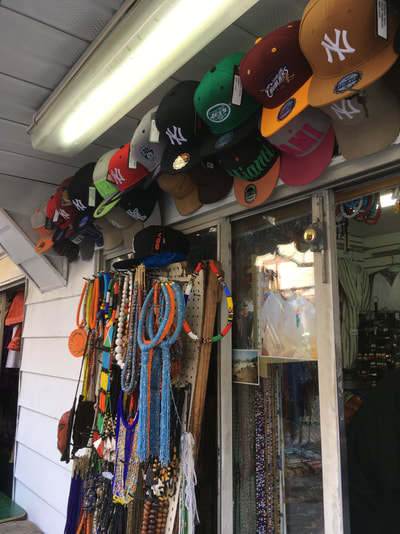 Caps and various items displayed outside shop
