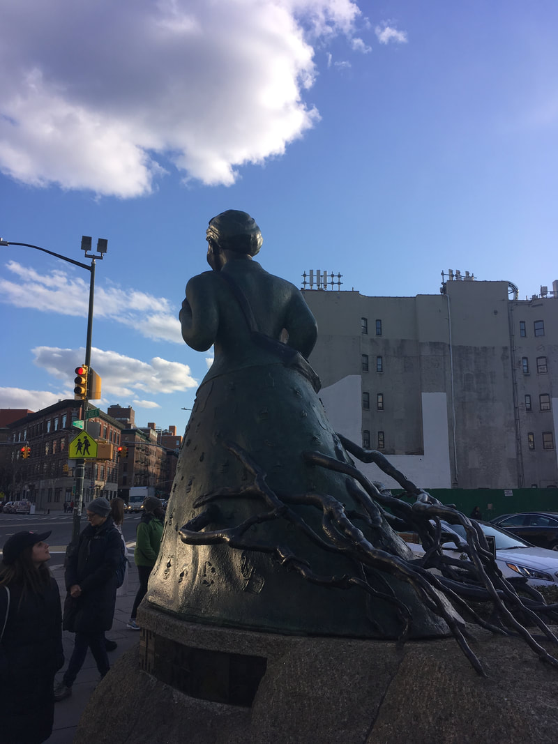 Back of Statue facing concrete buildings