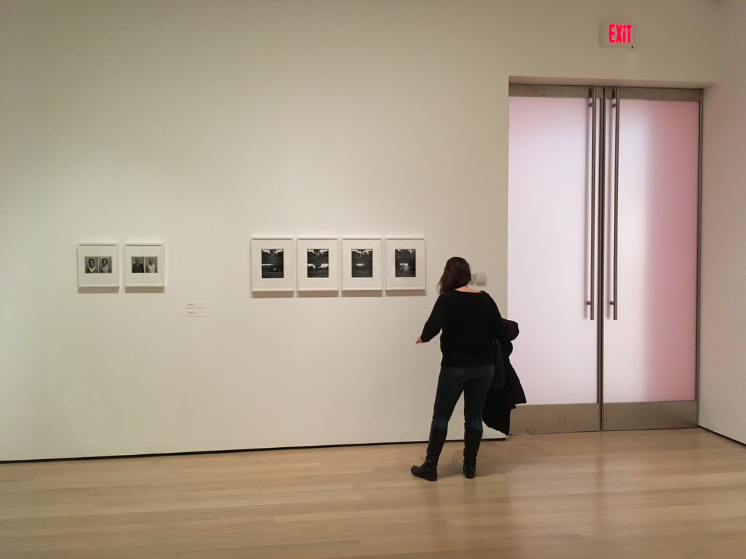 Person looking at Exhibit of black and white images
