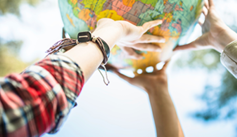 Hands outstretched holding a globe