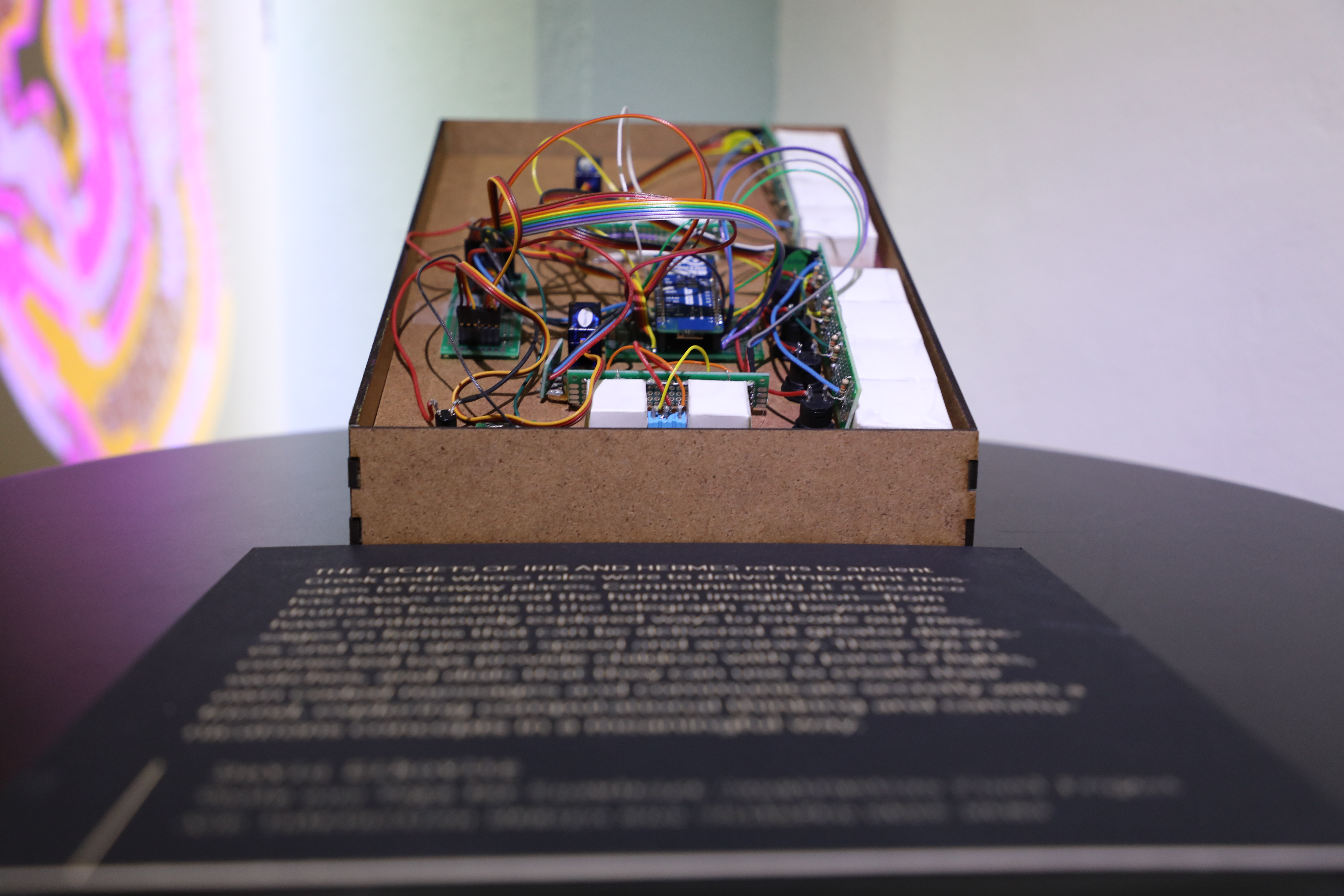 Image of box with wires with unreadable description in front of it 