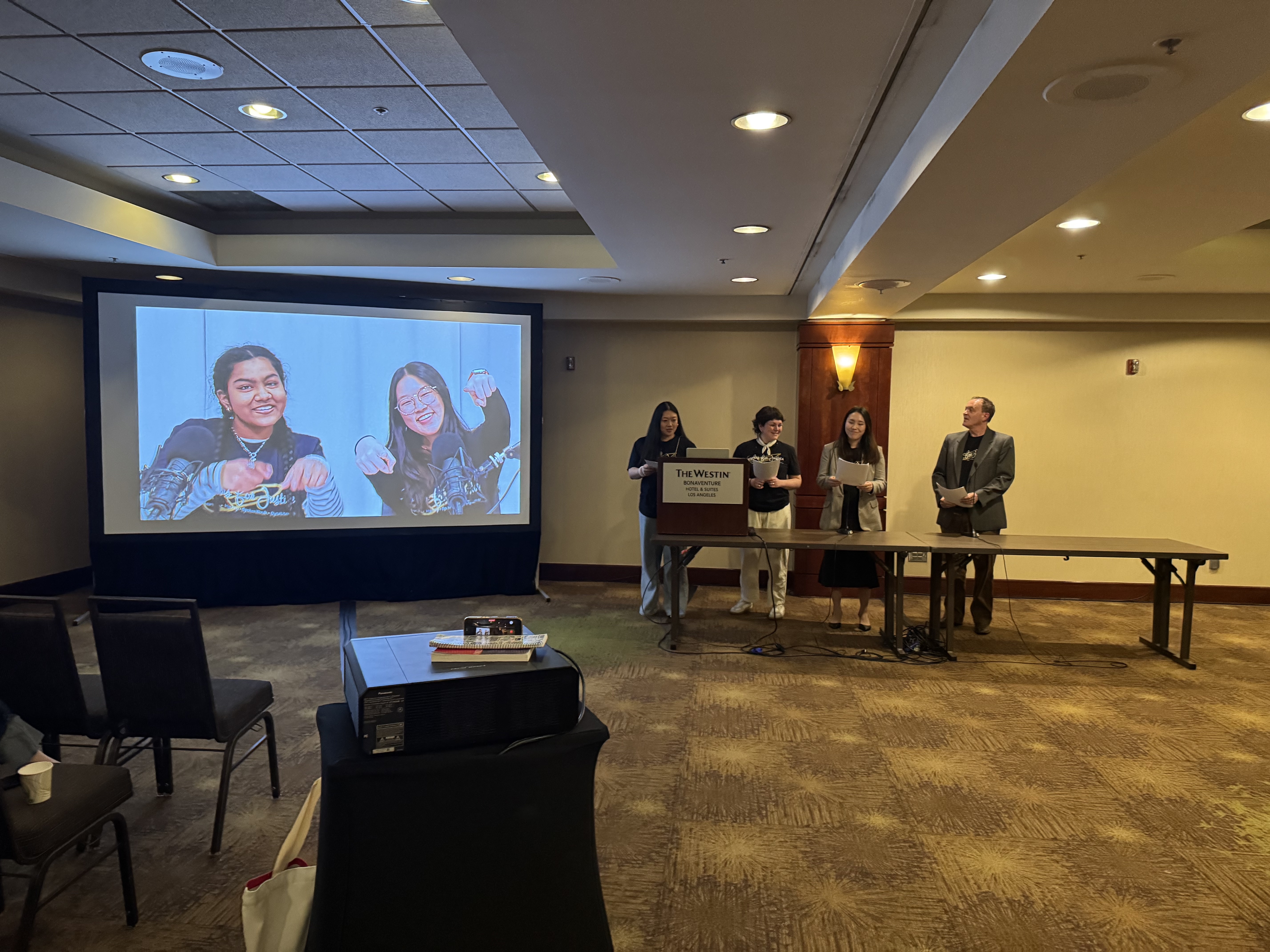 From left to right: Emily, Chloe, Yami Cao, Miranda McGough, Andrea Kim, and John McGinty presenting at the AERA Division C Shark Tank, 2026, Los Angeles.
