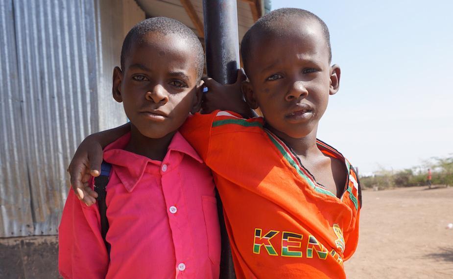 Two boys pose for a photo at Kakuma