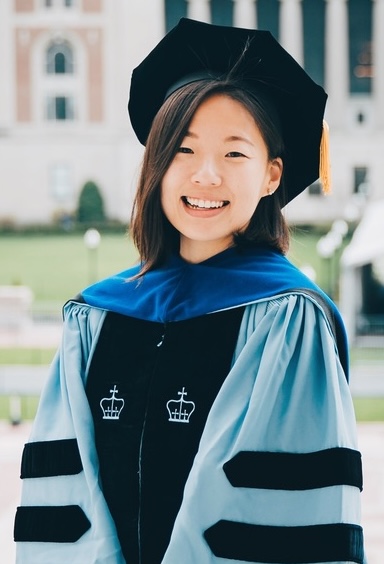 A woman in a Columbia University graduation robe