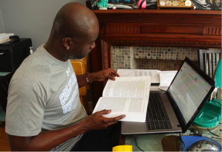 A student studies at a computer in his home