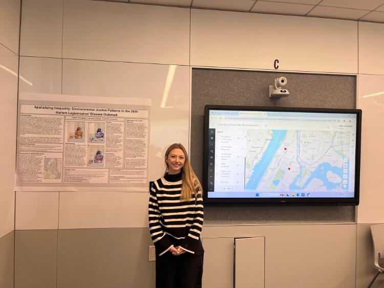 Image of Science Education student Fallon in front of her research display