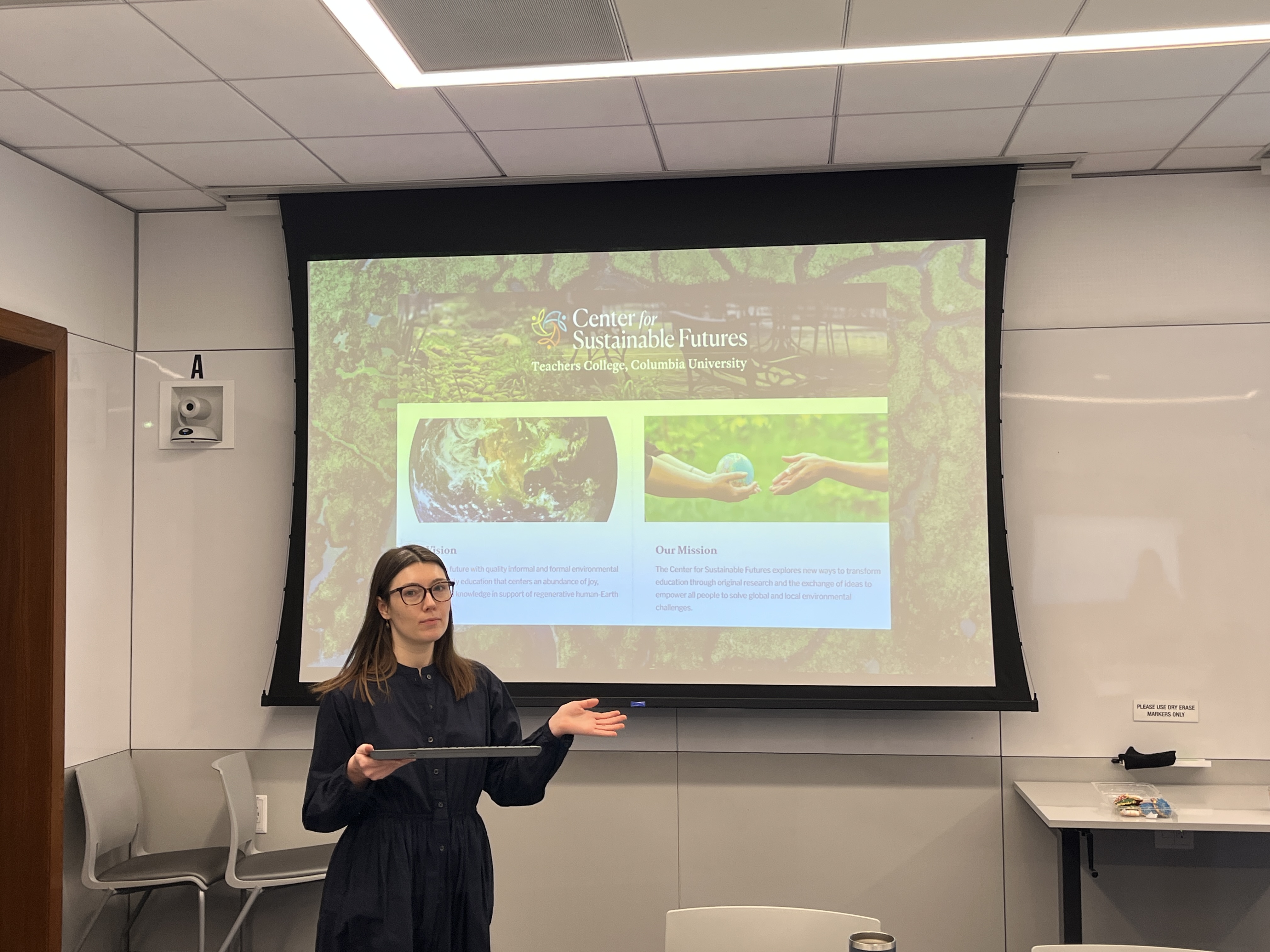 Student Emily in front of her presentation slideshow