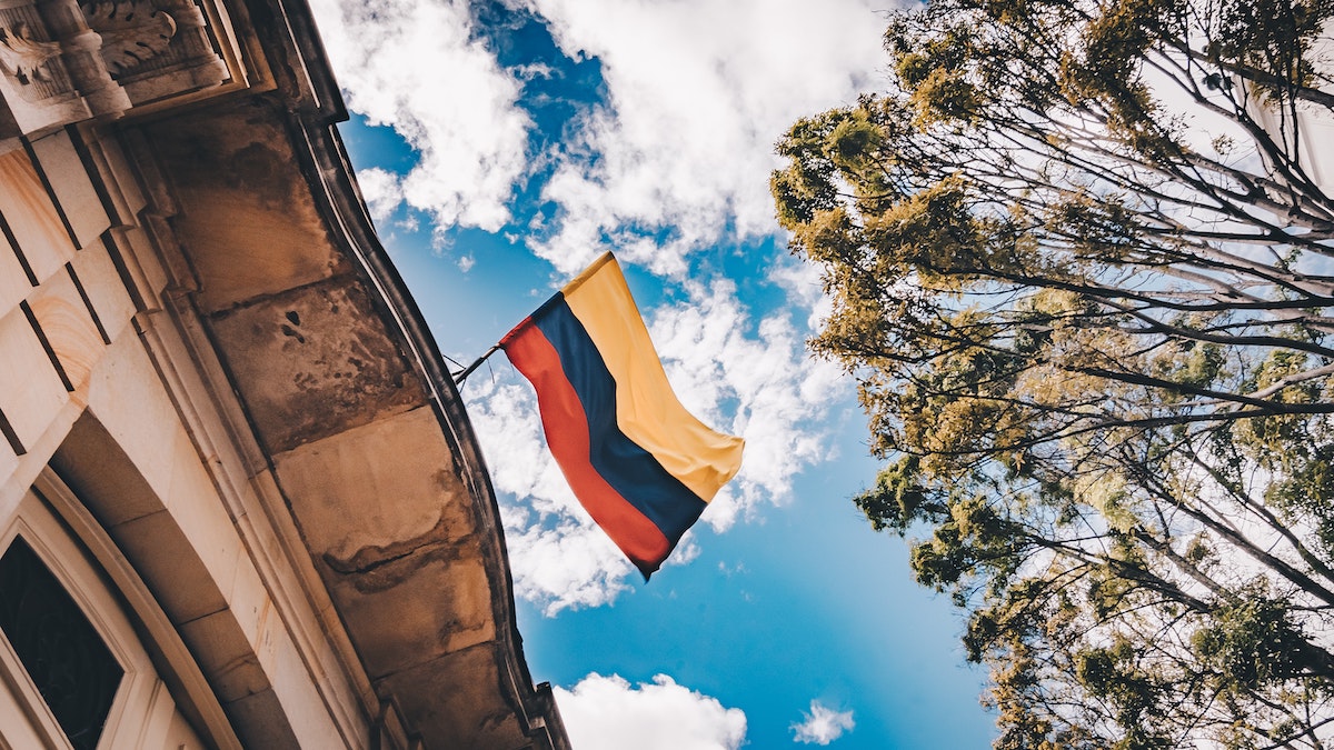 A Colombian flag waving on the roof of a building