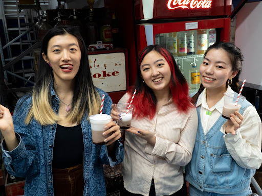 Three members of the design team enjoying egg creams!