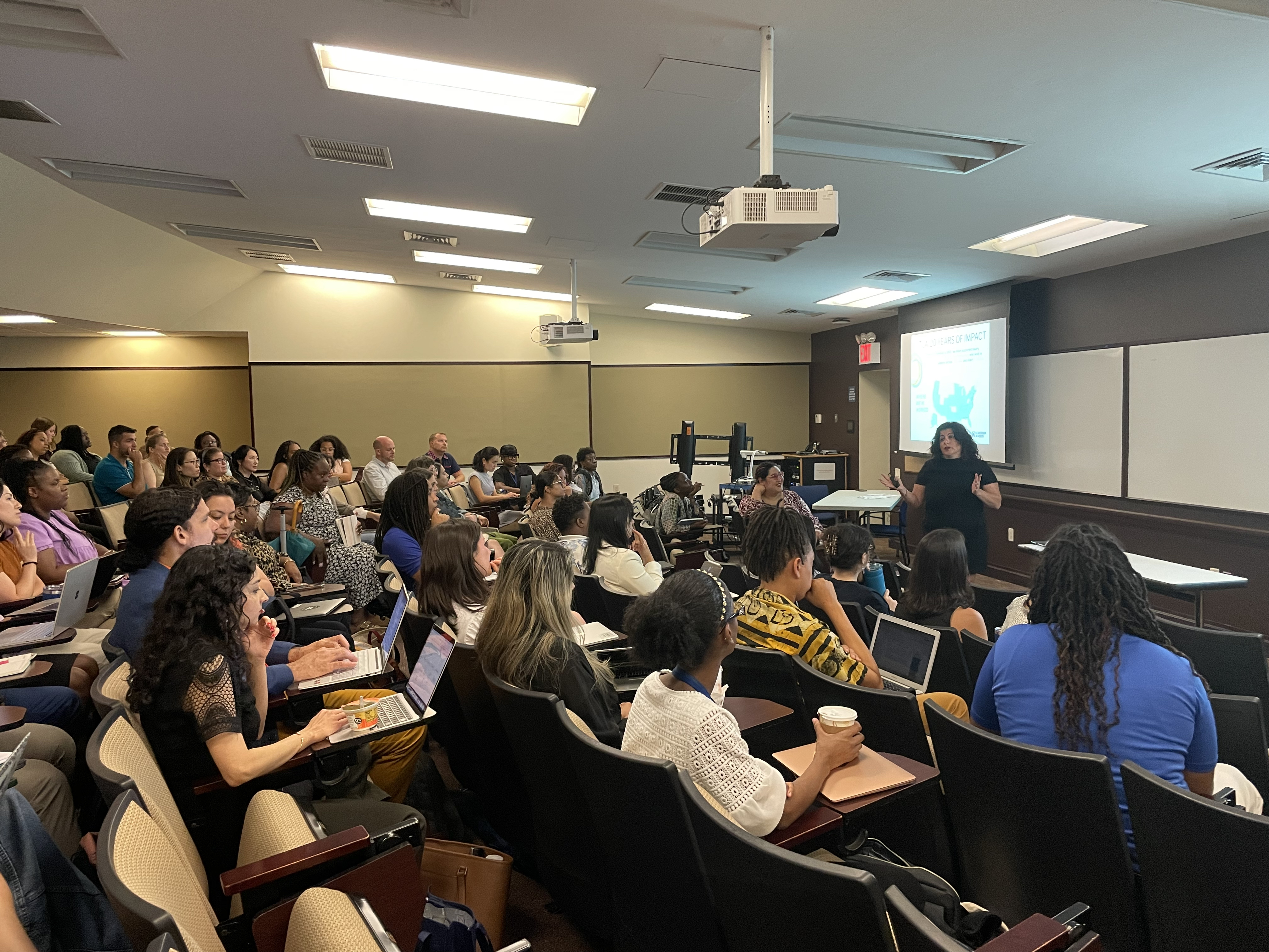 Students sitting in class listening to a speaker.