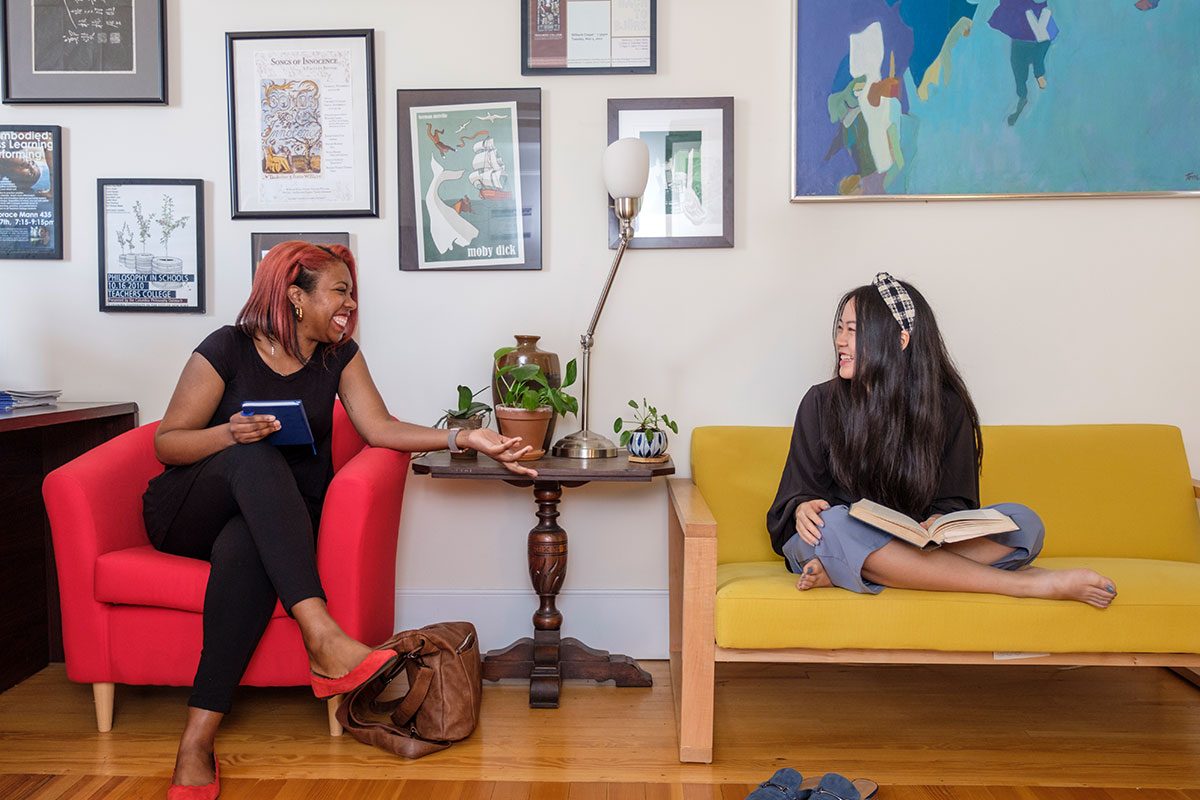 Two students having a discussion inside a lounge