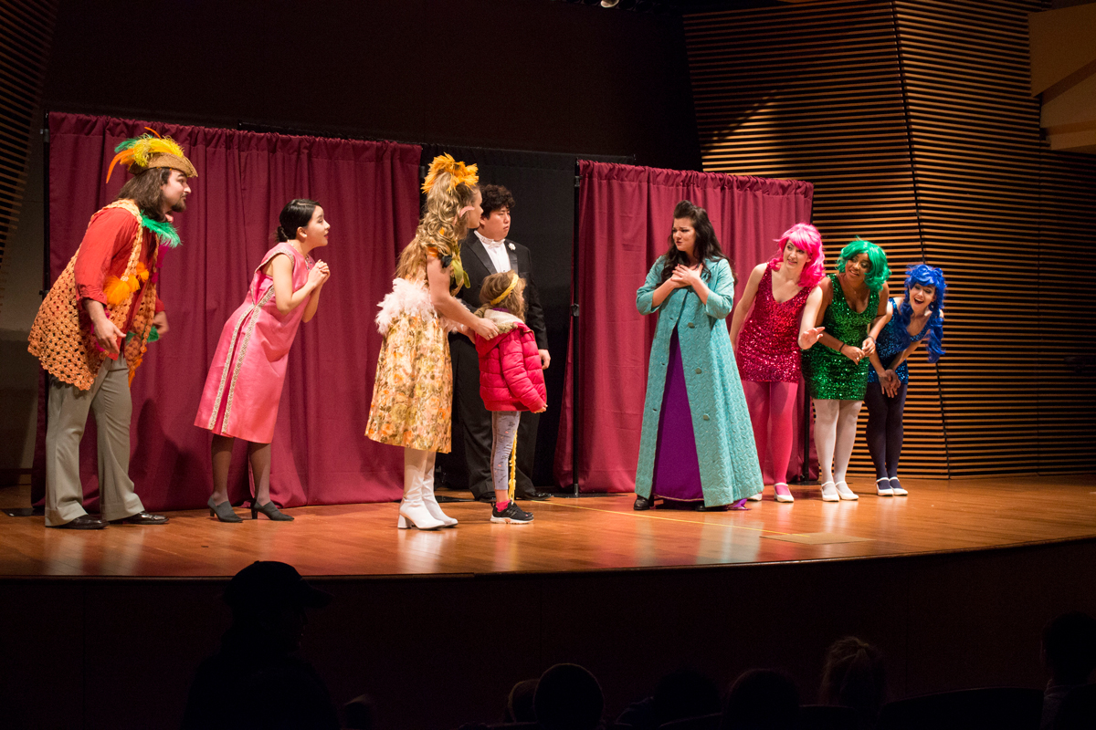 Students perform on stage in a play