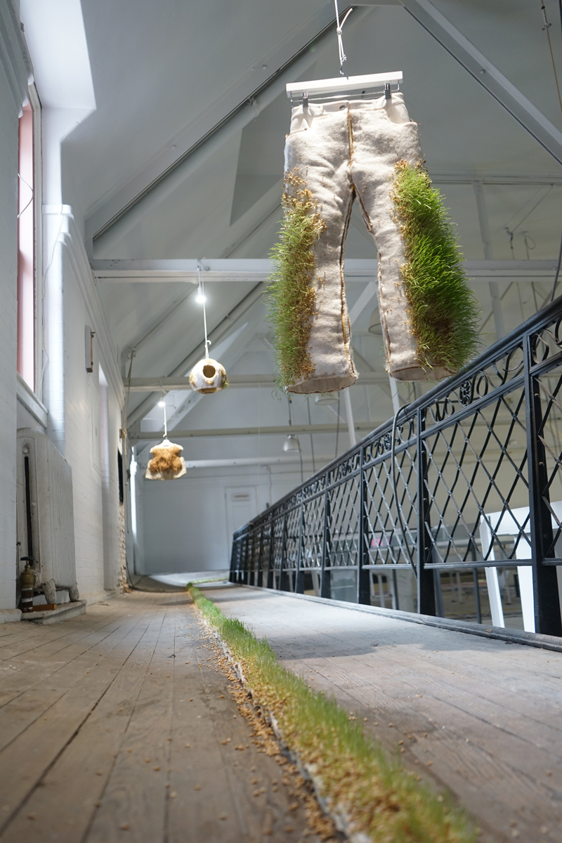 Pants made out of natural materials hang above an old track