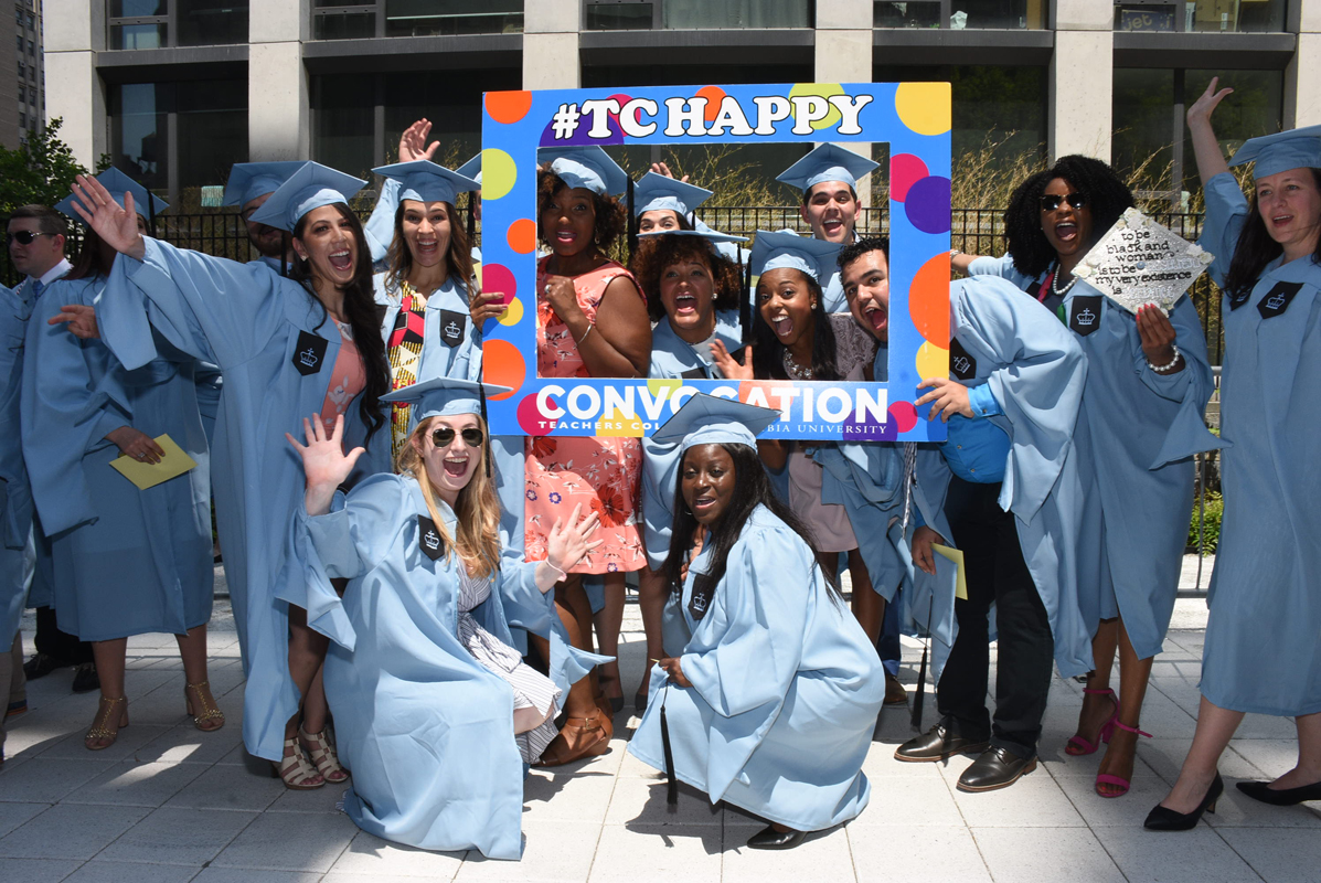 Students pose with TC Happy sign at Convocation