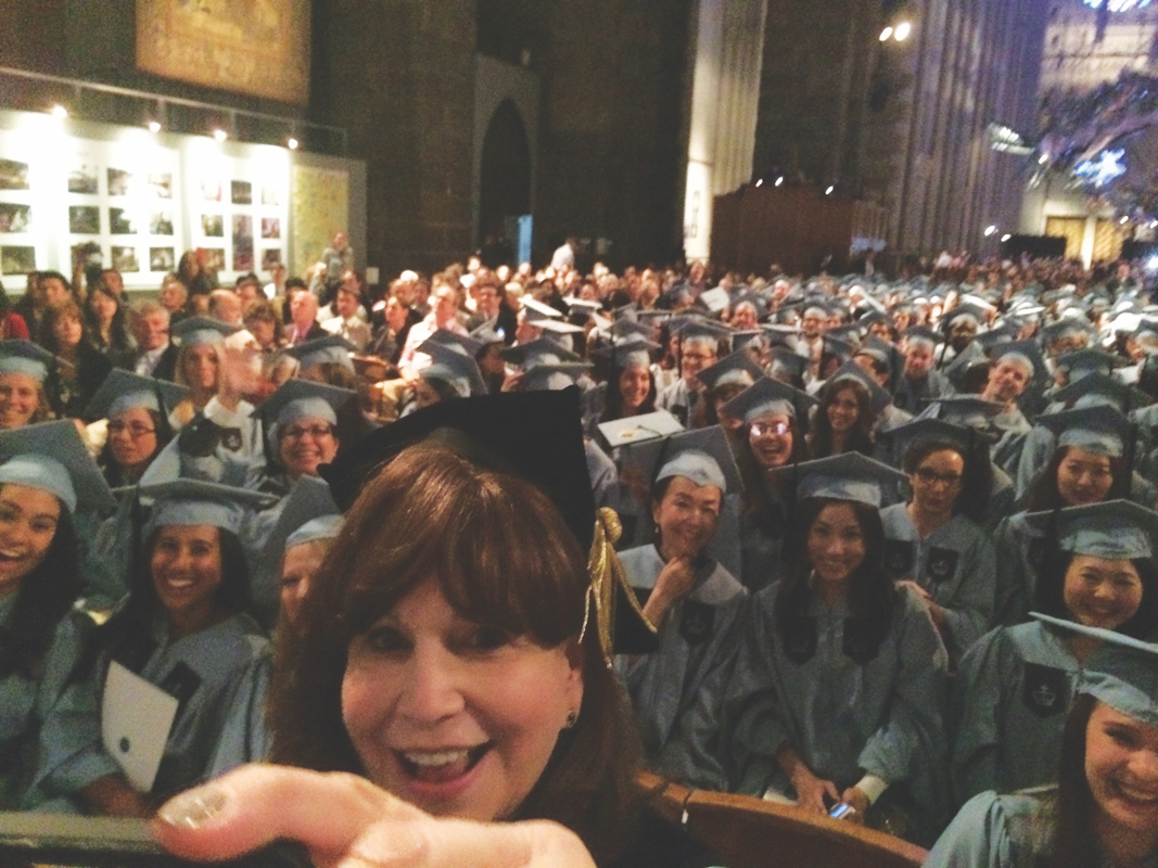 Susan Fuhrman takes a selfie with students at Convocation