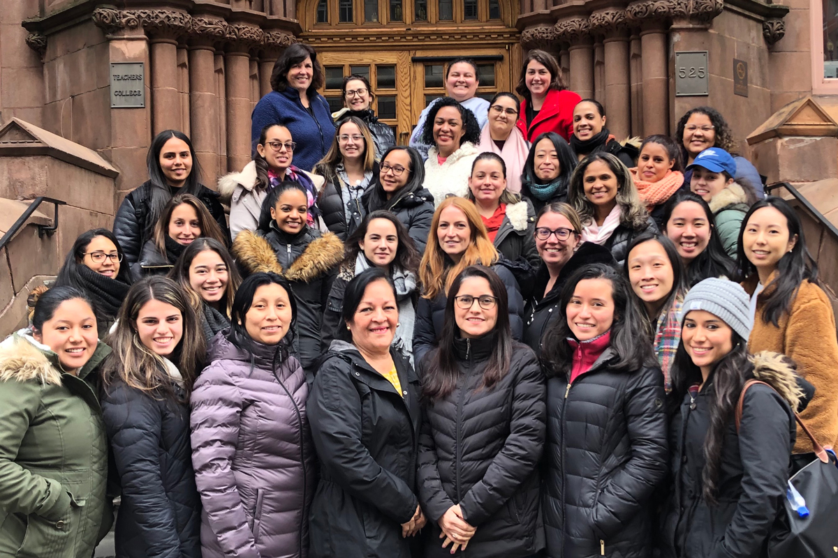 The students of the 2019 cohort pose with Cate Crowley on the steps of Teachers College