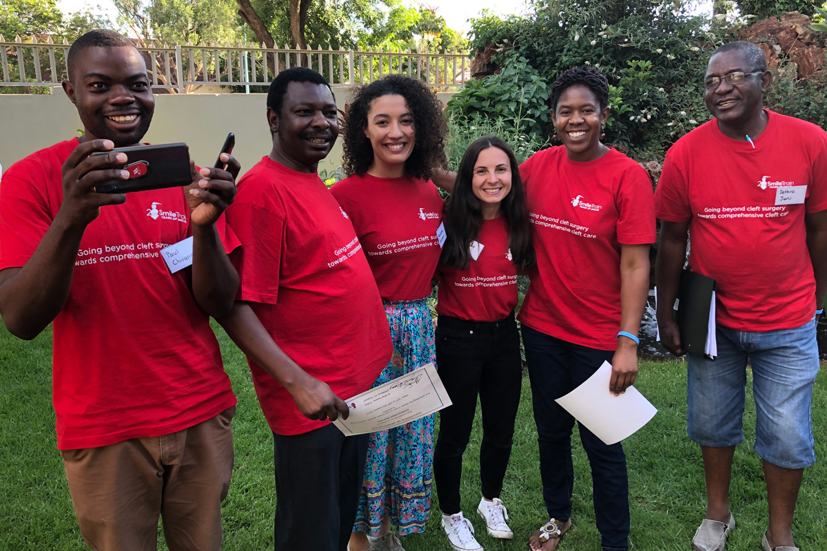 Makaela and Celeste pose with participants in Zimbabwe