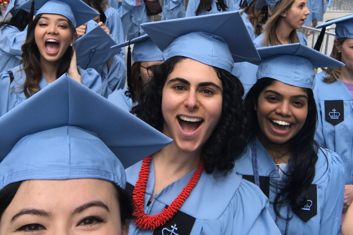 Students smiling at graduation.