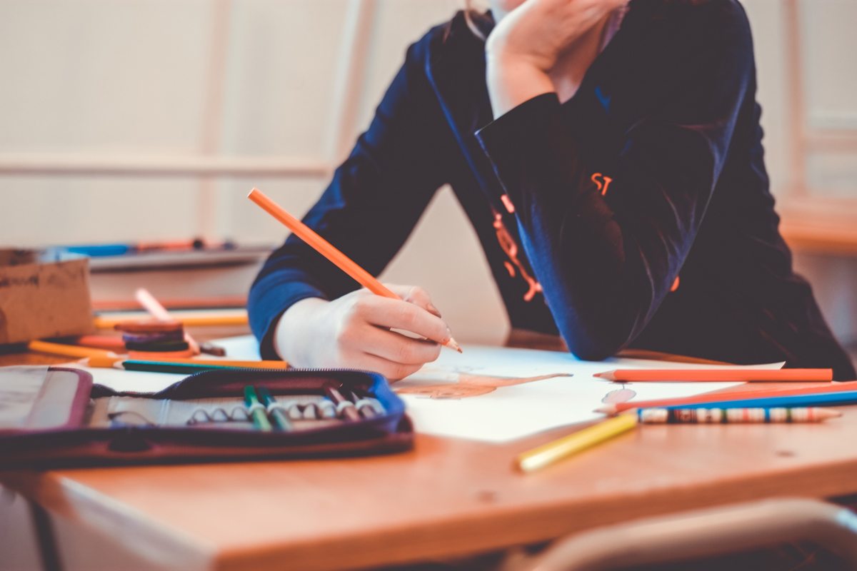 Student writes or draws in class.