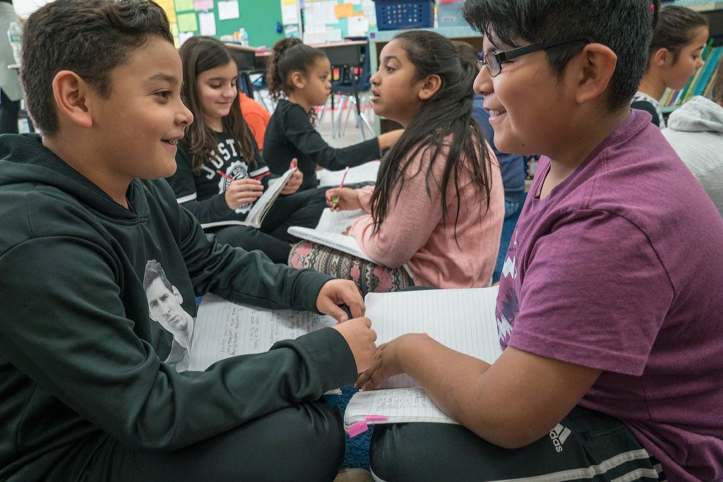 Boys and girls reading in a classroom