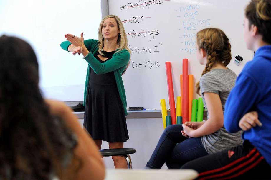 A Deaf Education graduate student teaches in a classroom.
