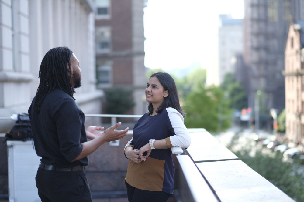 Two students in conversation outside of Teachers College