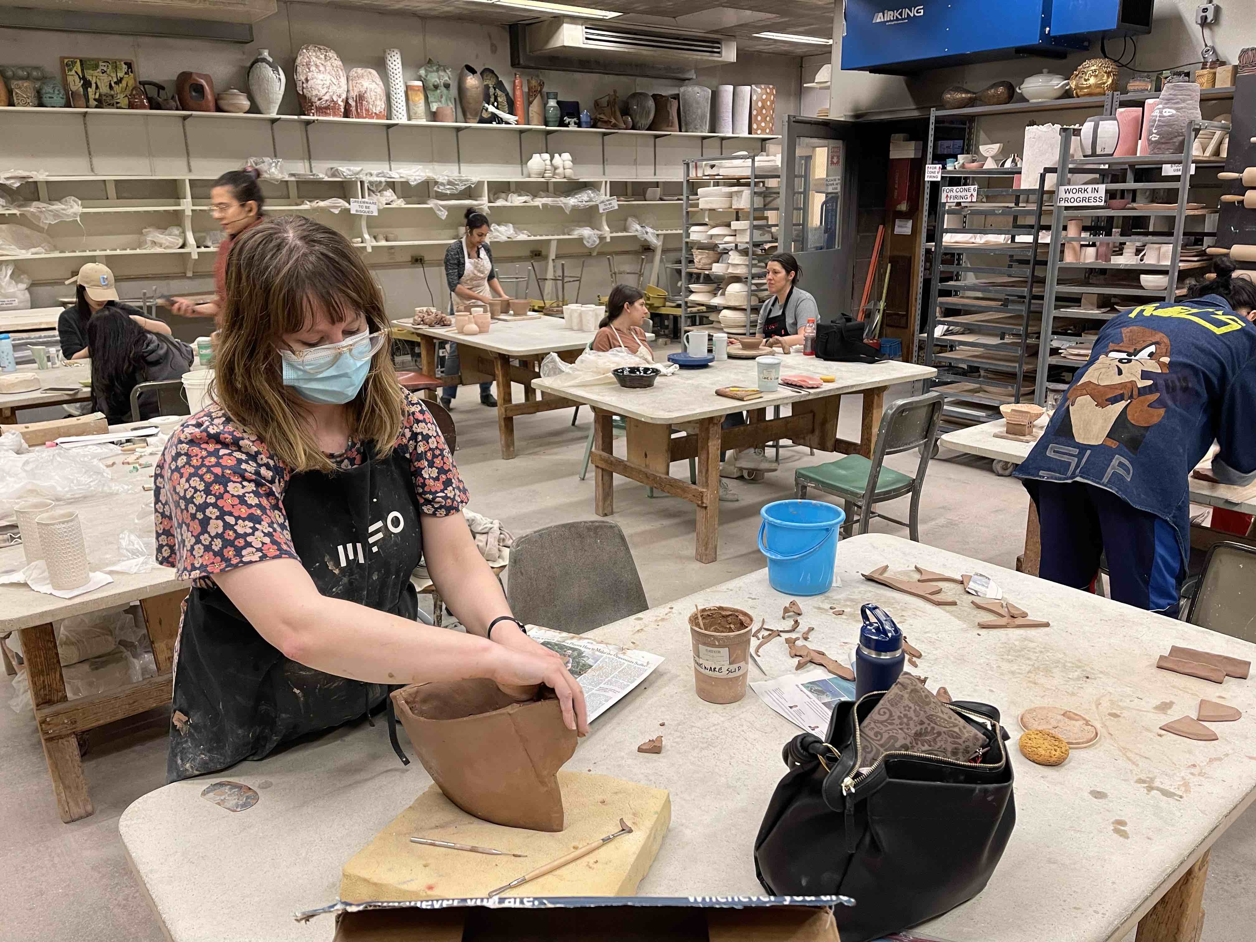 This is a picture of a graduate student creating the ceramics studio.