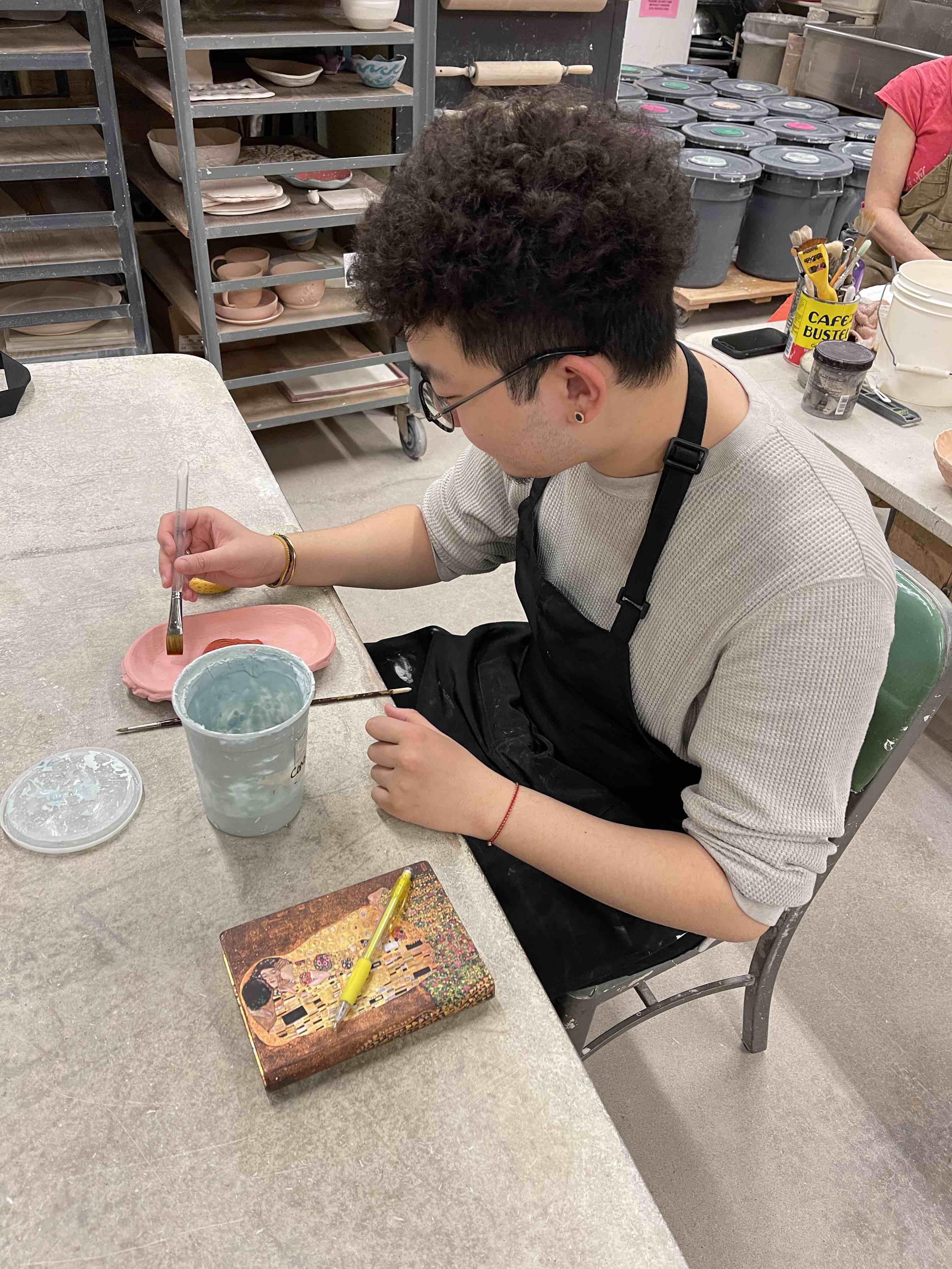 This is a picture of a graduate student creating the ceramics studio.