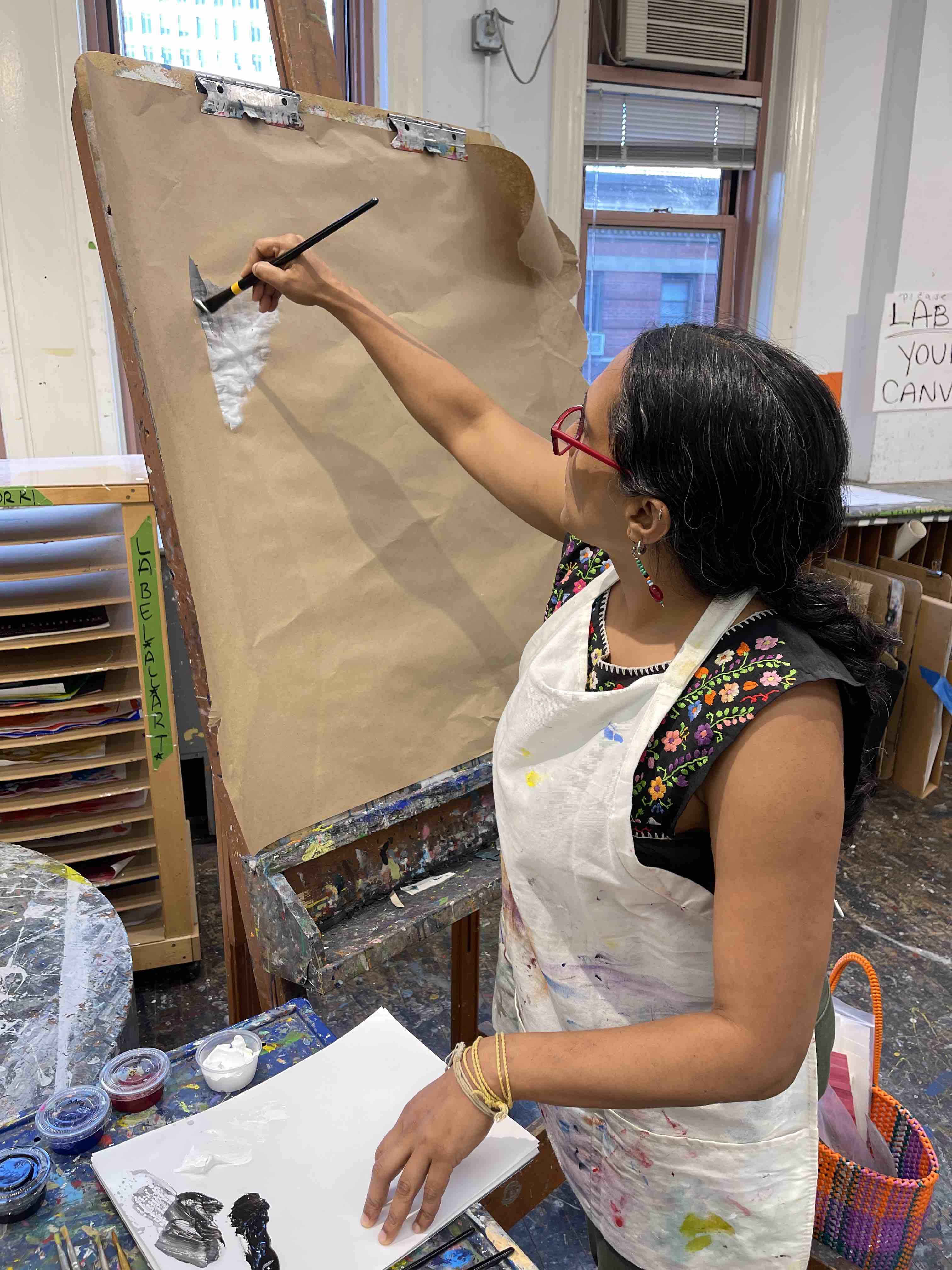 A graduate student painting in the Macy Art Studio.