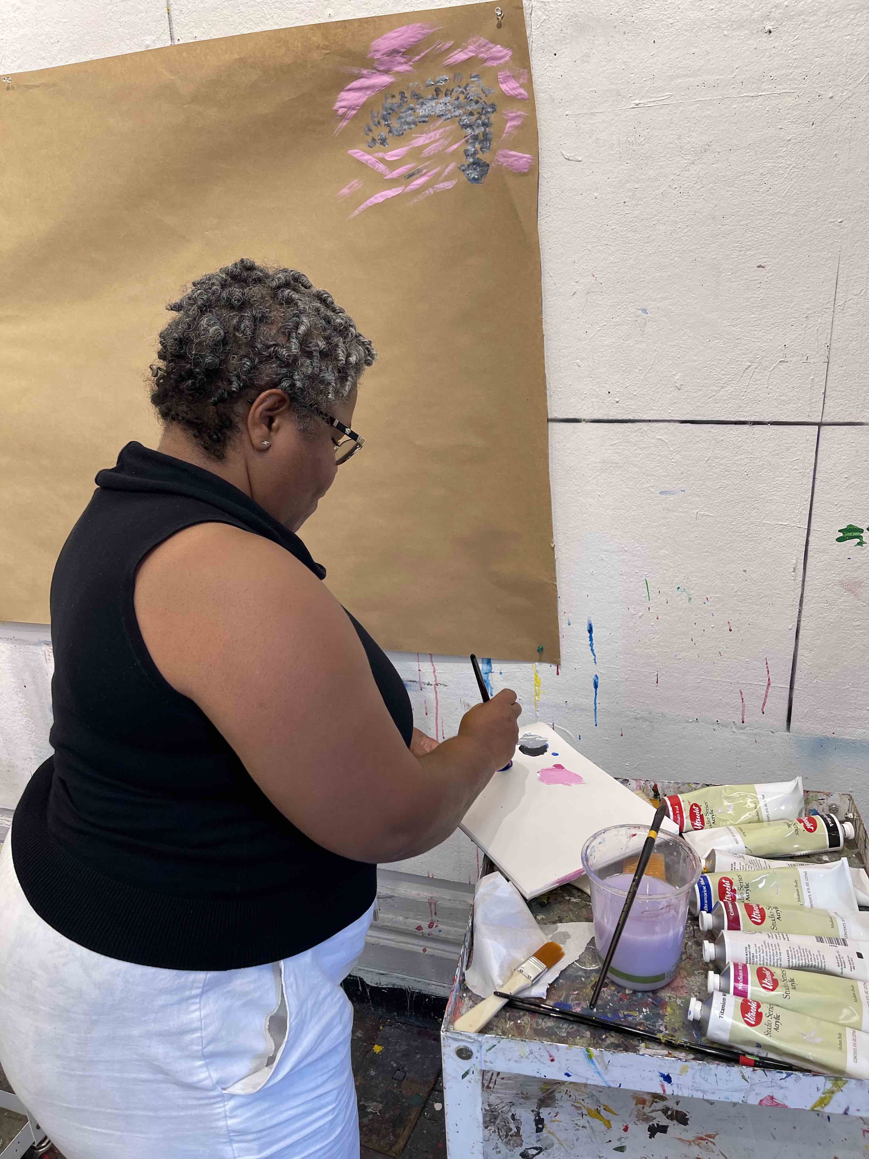 A graduate student preparing the painting palette.