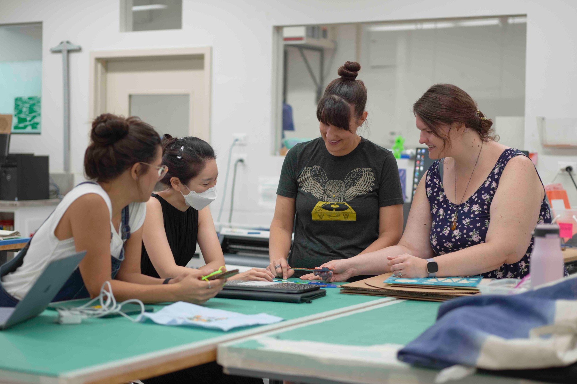 This is a picture of graduate students in the Thingspace studio working on a project.