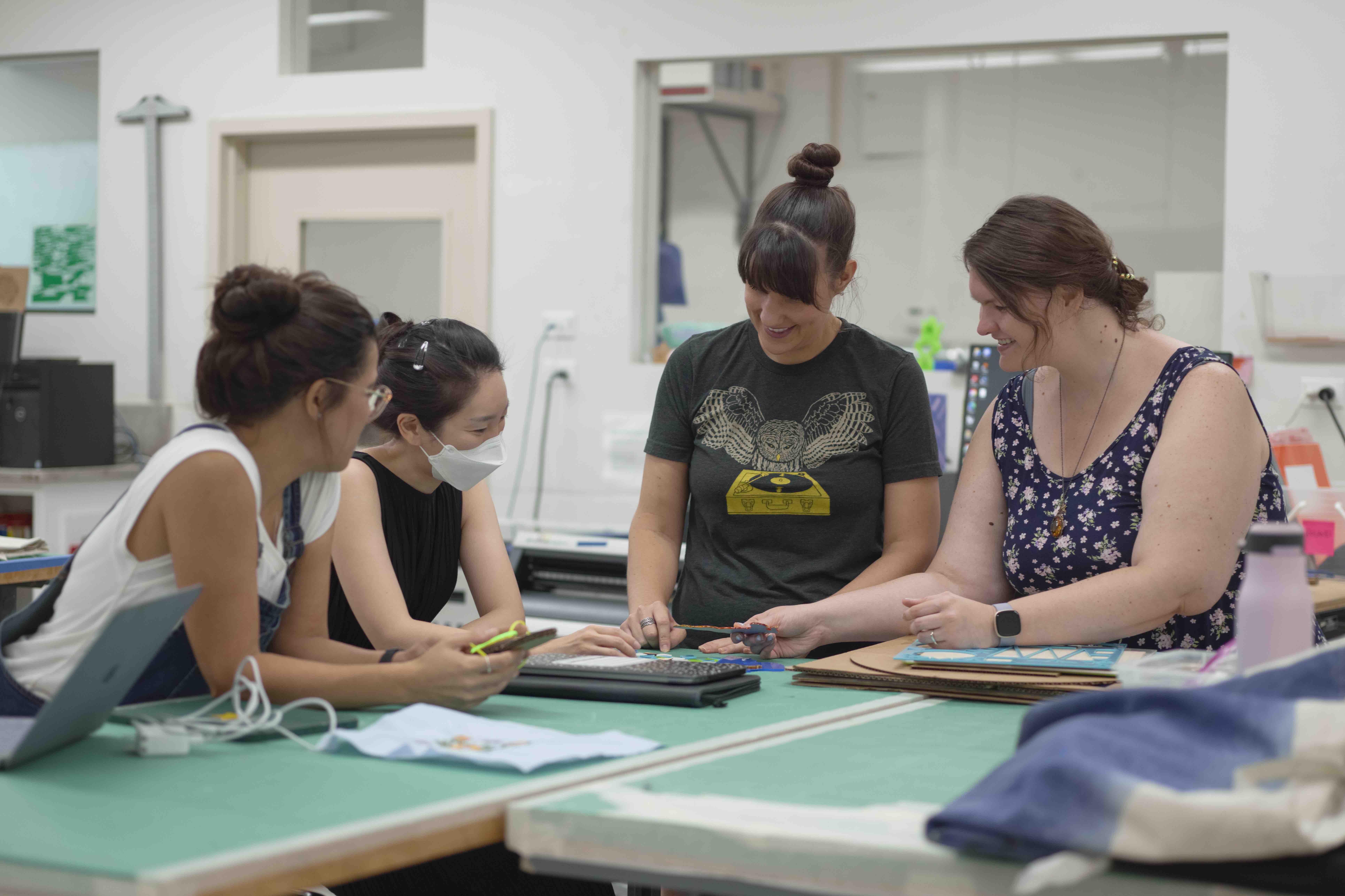 This is a picture of graduate students in the Thingspace studio working on a project.